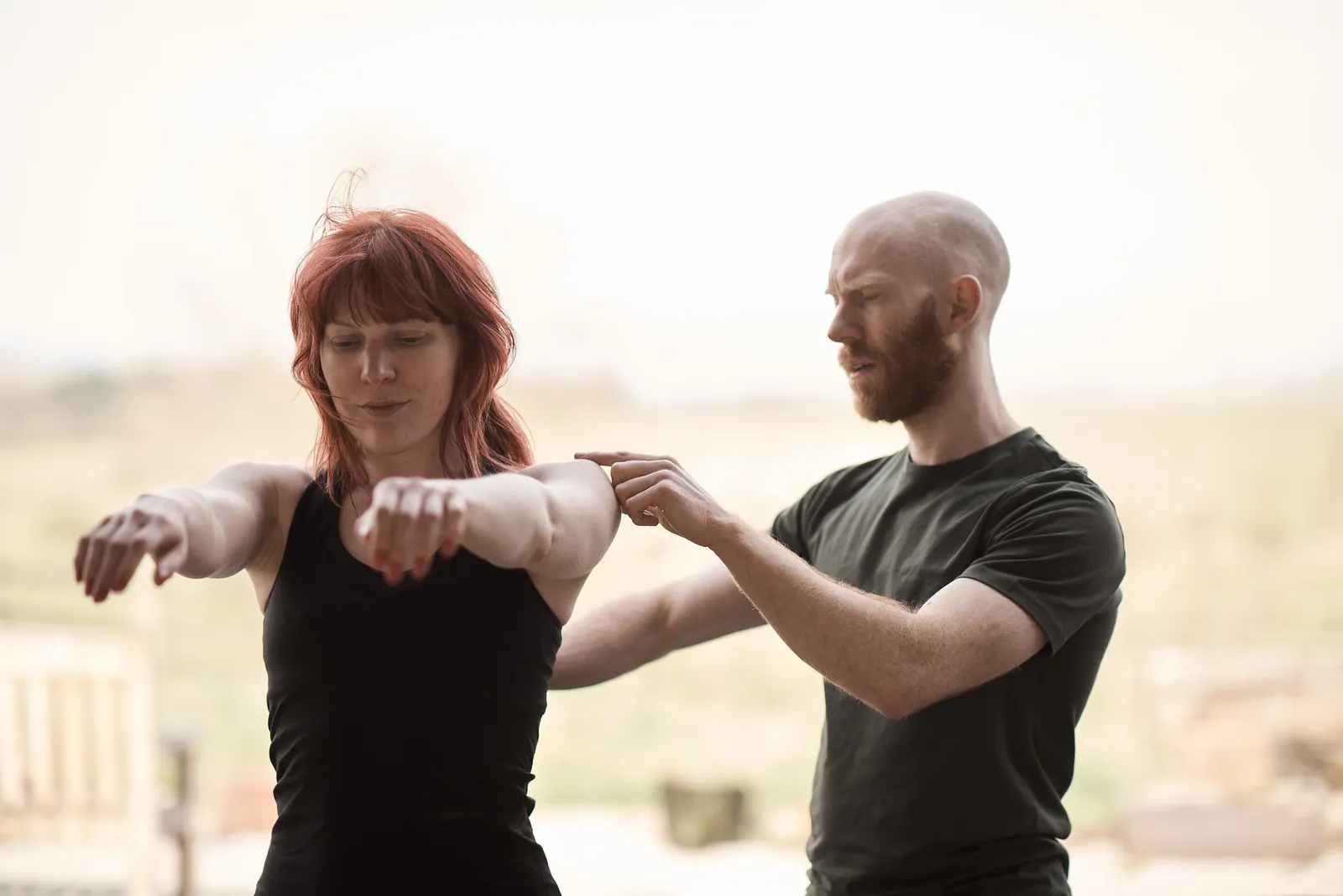 David Graham guiding a patient through a shoulder and arm movement assessment